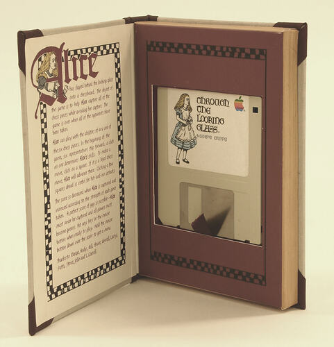 Through the Looking Glass game disk inside its original book-shaped packaging